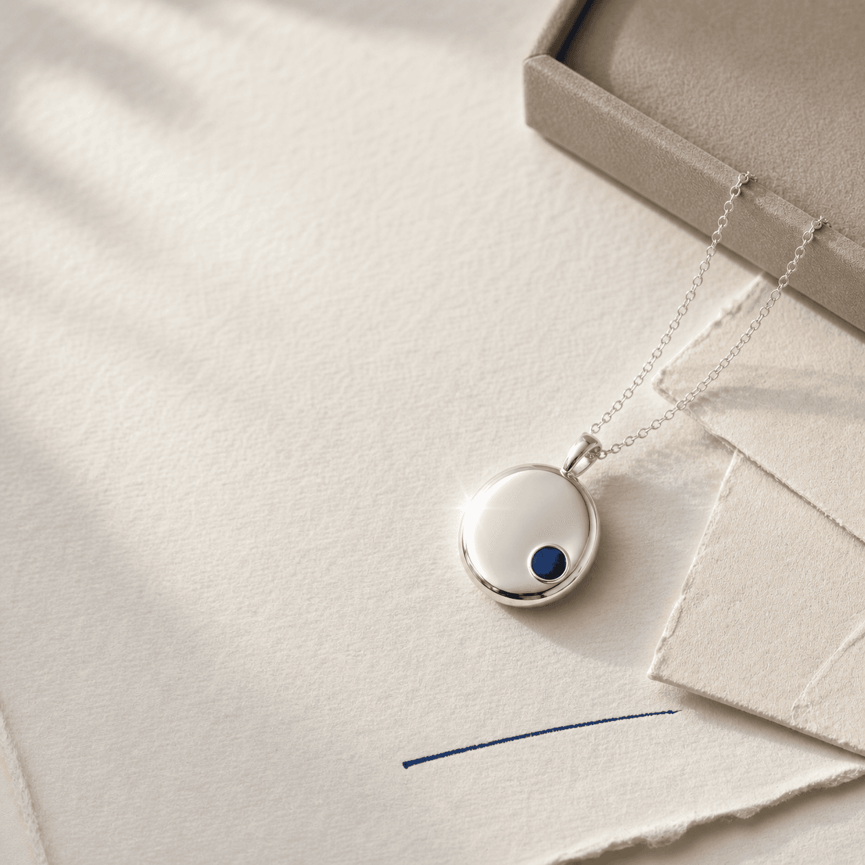 Adlume concept of the same fictional SERA pendant in a founder-note editorial scene